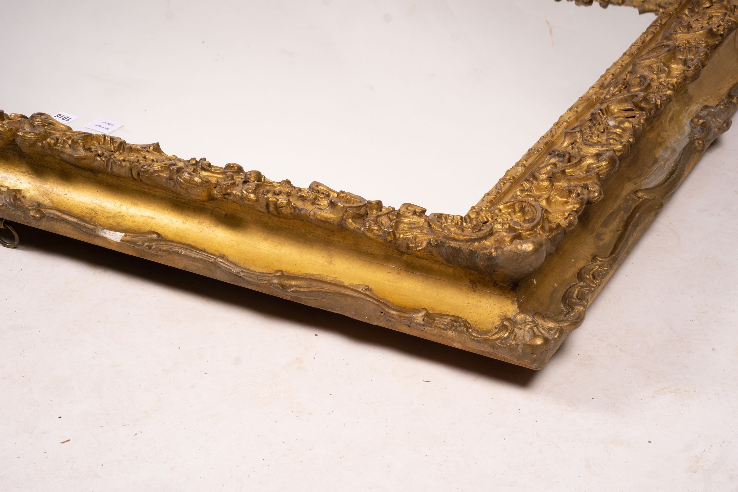 An ornate Victorian giltwood and gesso rectangular wall mirror (formerly a picture frame) width 130cm, height 112cm